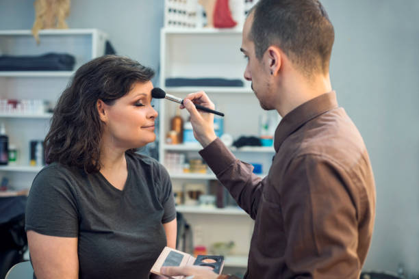 Professional makeup artist demonstrating the proper technique for using makeup brushes
